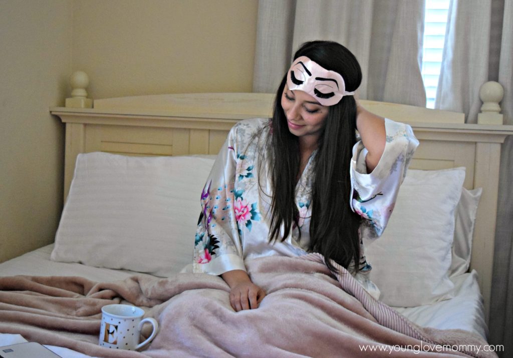 woman laying in bed with coffee mug, how to sleep better, sleep hygiene