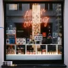 Analog camera shop window with film cameras and neon sign reading “All for analog,” representing a low-tech lifestyle and intentional living in 2026