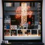 Analog camera shop window with film cameras and neon sign reading “All for analog,” representing a low-tech lifestyle and intentional living in 2026
